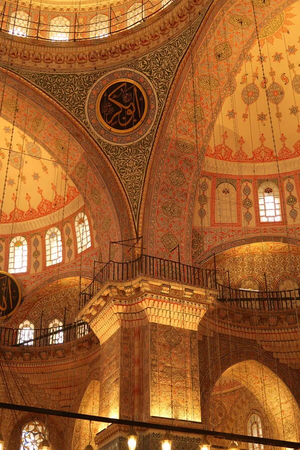Hagia Sophia's painted domes and gilded roundels seen from the gallery, lit gold.